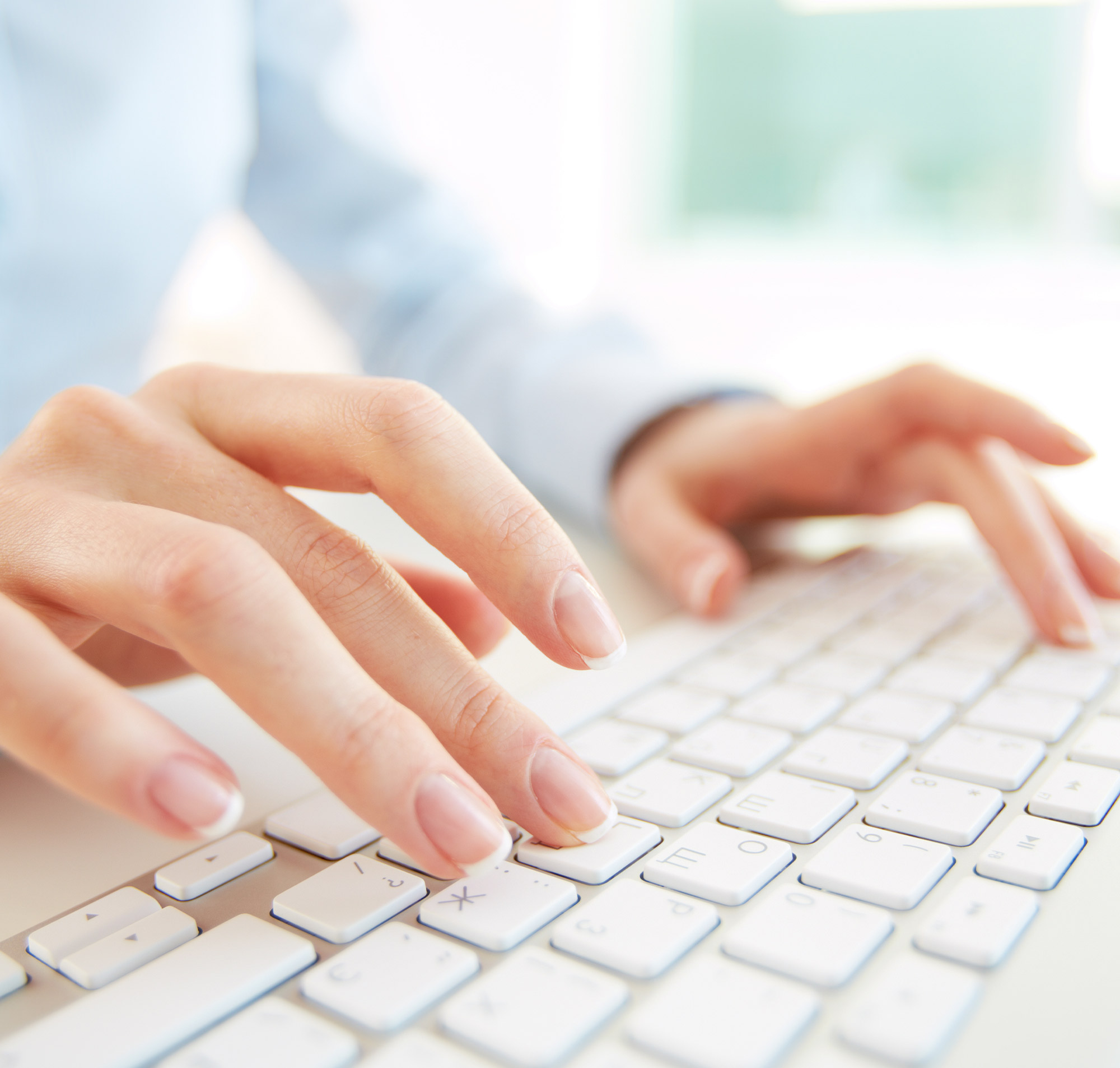 Nahaufnahme von Händen, die auf einer modernen Tastatur tippen, ideal für Büro- und Arbeitsumgebungen.